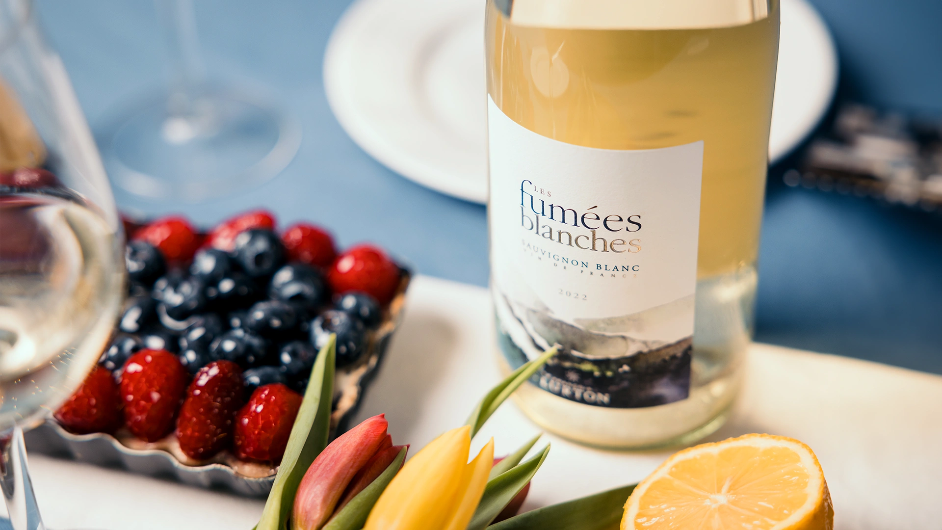 Close up of French Wine, flowers, and fruit
