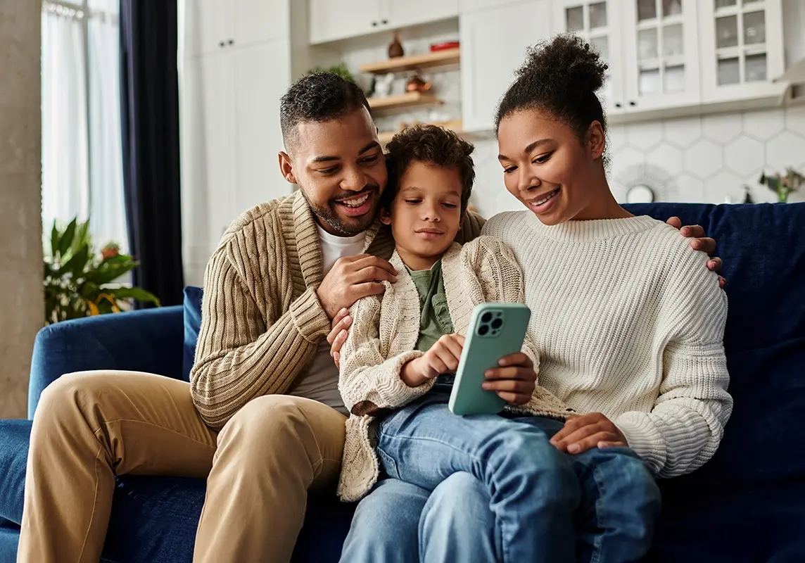 Family looking at mobile phone together